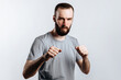 © Daria Lukoiko - Portrait of handsome young man frowning while looking at camera holding fists and boxing on white background with space for advertisement mock up