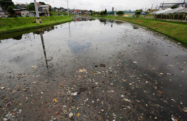 Aerial view of high quantities of trash inside a canal near Negro River, downtown Manaus, located in Amazonas state, Brazil.