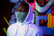 © VICTOR TORRES/Stocksy - Black man in hoodie and mask in urban area