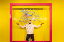 Black Man Scattering Confetti In Studio