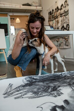 Painter In The Studio Playing With The Terrier Dog