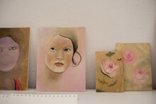 Close Up On Figurative Paintings In A Soft Palette