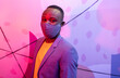 © VICTOR TORRES/Stocksy - Ethnic man in a mask in a colourful room