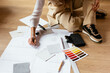 © BONNINSTUDIO/Stocksy - Crop designer creating blueprint on floor