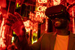 © VICTOR TORRES/Stocksy - Content black man in VR goggles in room with neon lights
