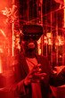 © VICTOR TORRES/Stocksy - Content black man in VR goggles in room with neon lights