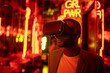 © VICTOR TORRES/Stocksy - Black man in VR goggles in room with neon lights
