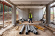 © Bisual Studio/Stocksy - Builder working on construction site of building