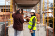 © Bisual Studio/Stocksy - Engineer and architect discussing construction project near building