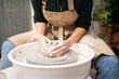 © Malquerida Studio/Stocksy - Close up of ceramist woman Making Clay Product With Pottery lathe in her studio