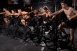 © Roman - group of young people cycling in modern fitness bicycle during group spinning class, shirtless men and beautiful women have intense workout training