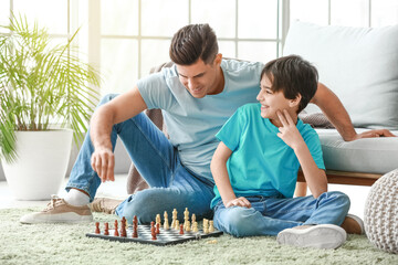 Poster - Father and son playing chess at home