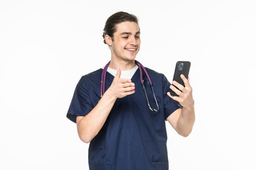 Medicine, healthcare and technology concept. Happy smiling doctor or male nurse in blue uniform with stethoscope having video call on smartphone over white background