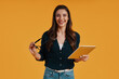 © gstockstudio - Confident young woman in smart casual clothing using digital tablet and smiling
