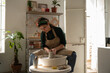 © Malquerida Studio/Stocksy - Ceramist young woman Making Clay vase With Pottery lathe in her studio