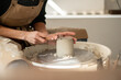 © Malquerida Studio/Stocksy - Close up of ceramist woman Making Clay vase With Pottery lathe in her studio