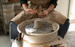 © Malquerida Studio/Stocksy - Close up of ceramist woman Making Clay bowl With Pottery lathe in her studio