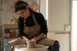 © Malquerida Studio/Stocksy - Ceramist young woman Making Clay vase With Pottery lathe in her studio