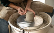 © Malquerida Studio/Stocksy - Close up of ceramist woman Making Clay bowl With Pottery lathe in her studio