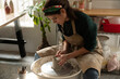 © Malquerida Studio/Stocksy - Ceramist young woman Making Clay vase With Pottery lathe in her studio