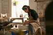 © Malquerida Studio/Stocksy - Ceramist young woman Making Clay vase With Pottery lathe in her studio