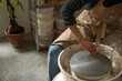© Malquerida Studio/Stocksy - Close up of ceramist woman cleaning Pottery lathe in her studio
