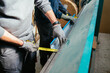 © David Prado/Stocksy - Crop worker using measuring tape at factory in a bending machine