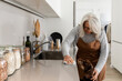 © Valentina Barreto/Stocksy - mature woman cleaning the kitchen