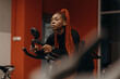 © Stereo Shot/Stocksy - Black sportswoman on exercise bike in gym