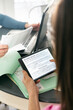 © Sean Locke/Stocksy - Taxes: Woman Reads Affordable Healthcare Act Information On Tabl
