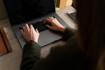 Woman working on laptop in the office.