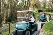 © Sergio Marcos/Stocksy - Women driving golf carts in park