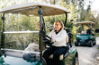 © Sergio Marcos/Stocksy - Women driving golf carts in park