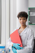 © Hernandez & Sorokina/Stocksy - Female Scientist Holding Folder