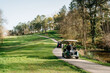 © Sergio Marcos/Stocksy - Women driving golf carts in park