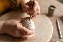 Woman's Hands Painting Clay Egg 
