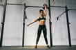 © Inuk Studio/Stocksy - Muscular Hispanic sportswoman lifting kettlebell over head