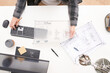 © Martí Sans/Stocksy - Professional engineer with blueprint working on computer