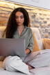 © Bisual Studio/Stocksy - Black female freelancer using laptop on couch