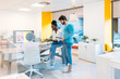 © VICTOR TORRES/Stocksy - Multiracial coworkers working with gadgets in office