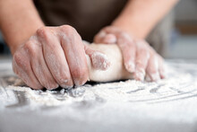 Hands Of A Man Kneading Bread Dough