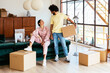 © BONNINSTUDIO/Stocksy - Multiracial couple laughing at joke during relocation
