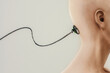 © Marcos Osorio/Stocksy - Side view of a shaved head with a wire attached to the head