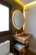 © Bisual Studio/Stocksy - Shelves with toiletries near toilet and mirror