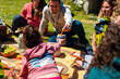 © Manu Prats/Stocksy - Contemporary people enjoying of traditional tasty meal at picnic outdoor