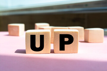 Canvas Print - Word UP made from wooden letters on pink background. Concept of growth