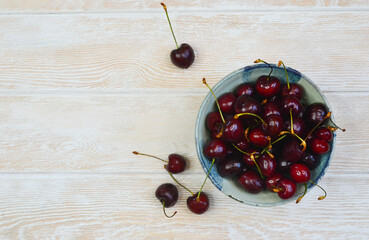 fresh and ripe cherry in a ceramic bowl, sweet summer berry