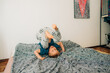 © Olga Moreira/Stocksy - Boy having fun on bed