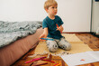 © Olga Moreira/Stocksy - Kid choosing markers for drawing