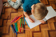© Olga Moreira/Stocksy - Kid drawing in a sketchbook at home